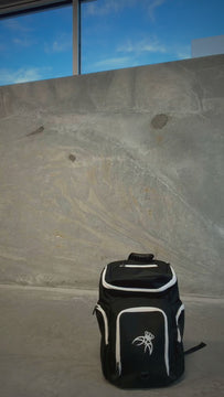 Player putting on the black Courtside Backpack