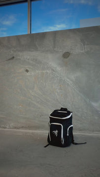 Player taking a basketball out of the Courtside Backpack front compartment